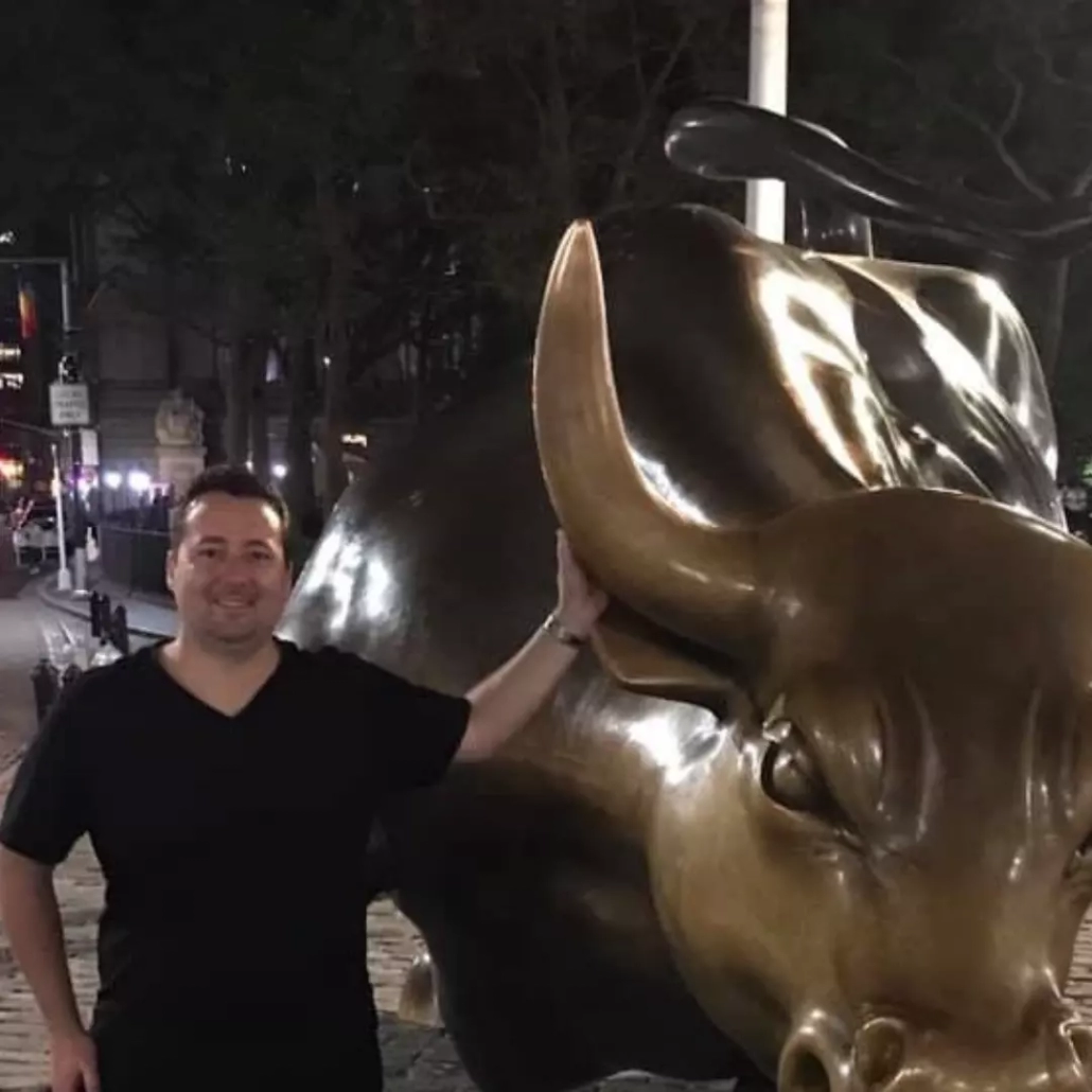 Rob Laurie with a golden bull statue.